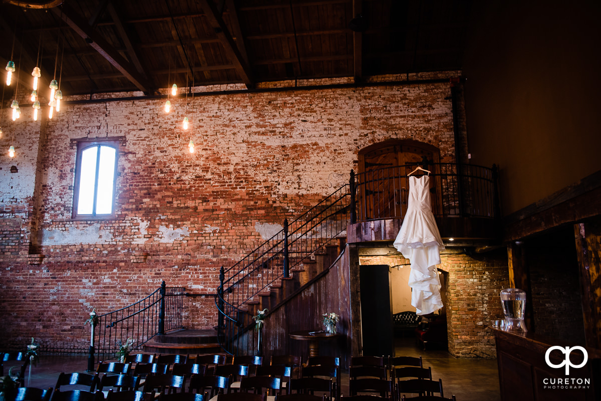 Bridal dress hanging in the Main Hall of The Old Cigar Warehouse in downtown Greenville,SC.