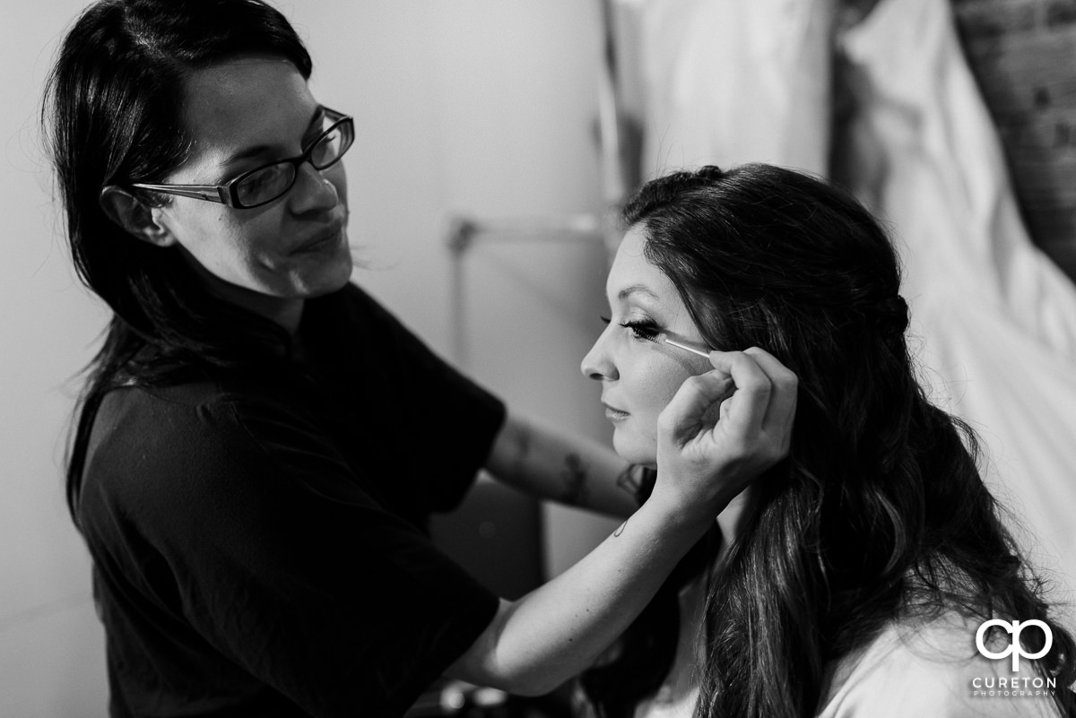 Bride getting makeup applied.