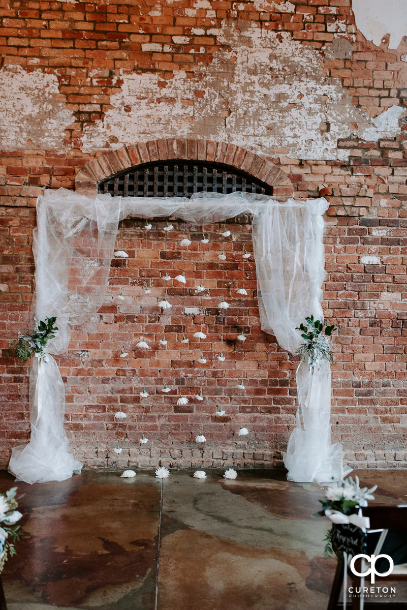 Arbor at the wedding ceremony by Dahlia a Florist.