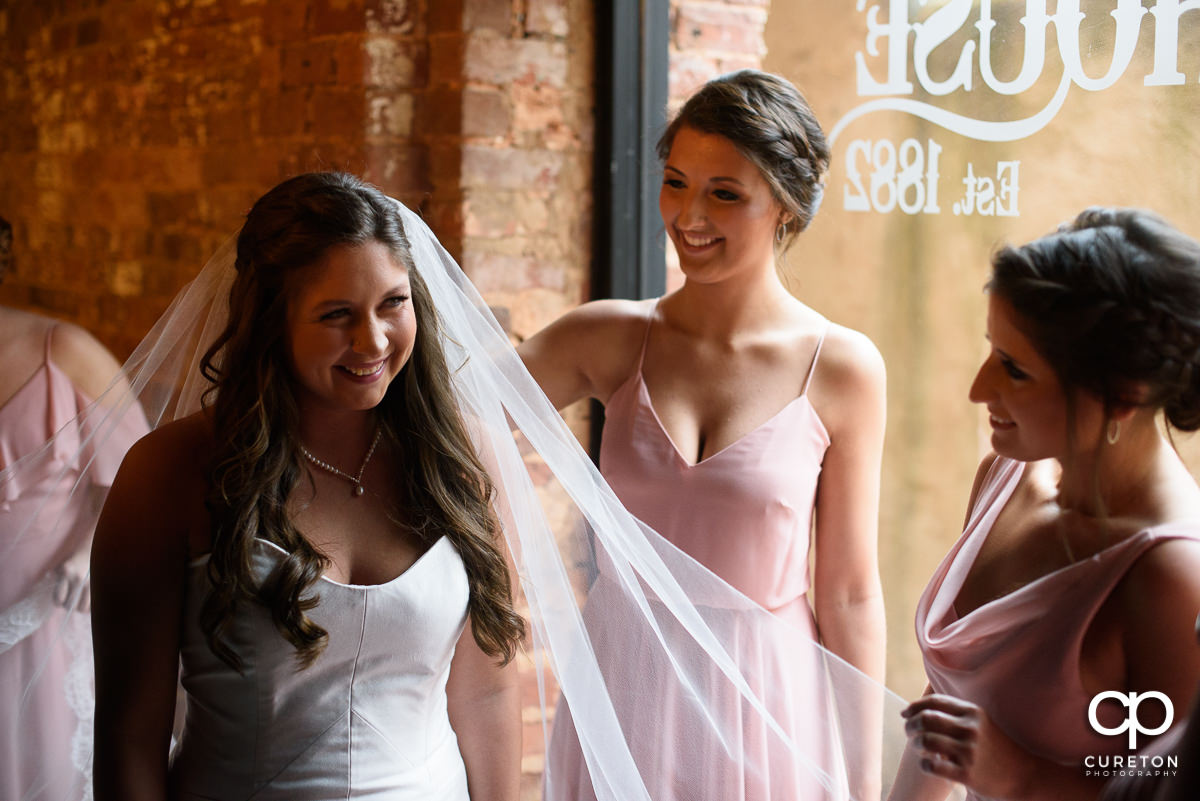 Bride smiling with her bridesmaids.