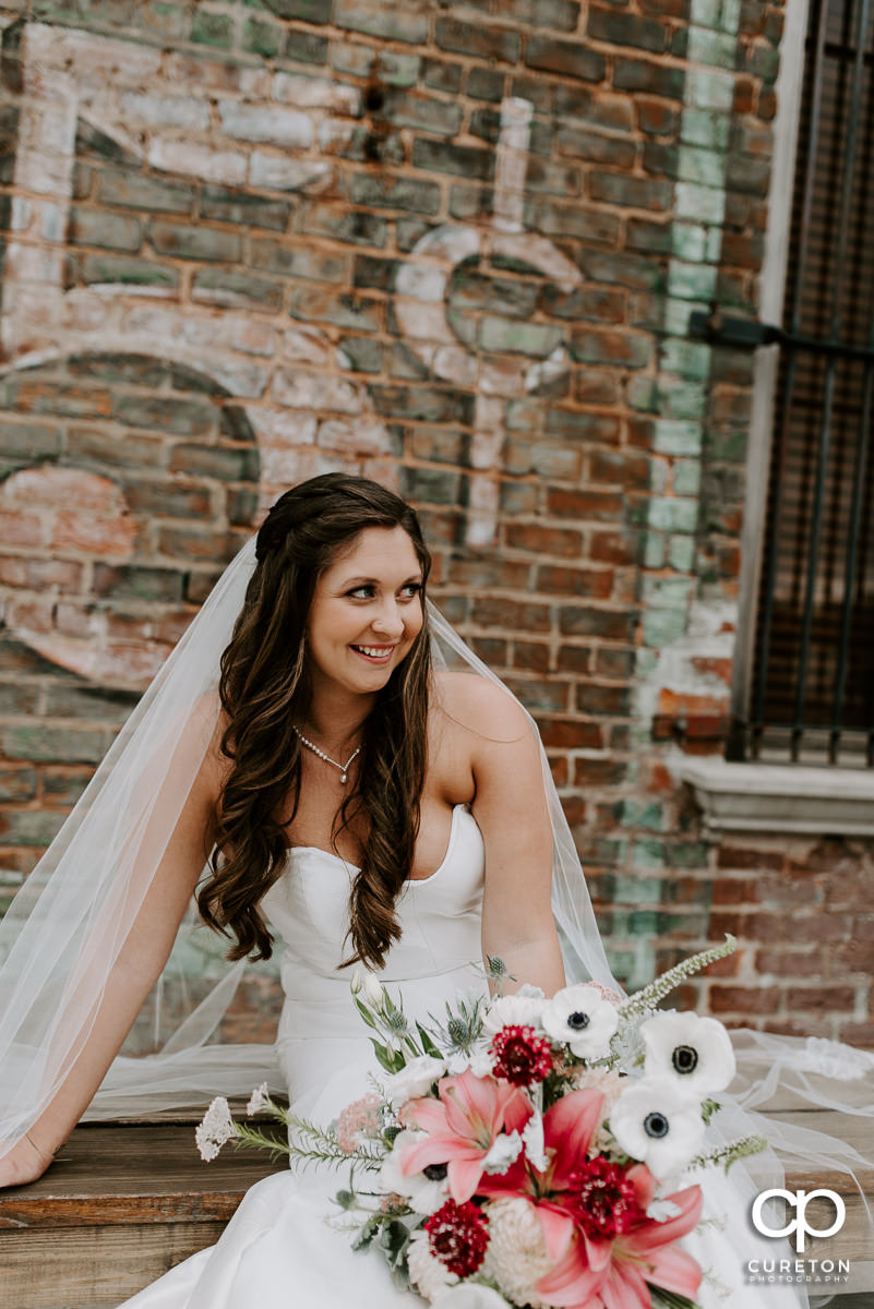 Bride laughing on the deck outside before her wedding.