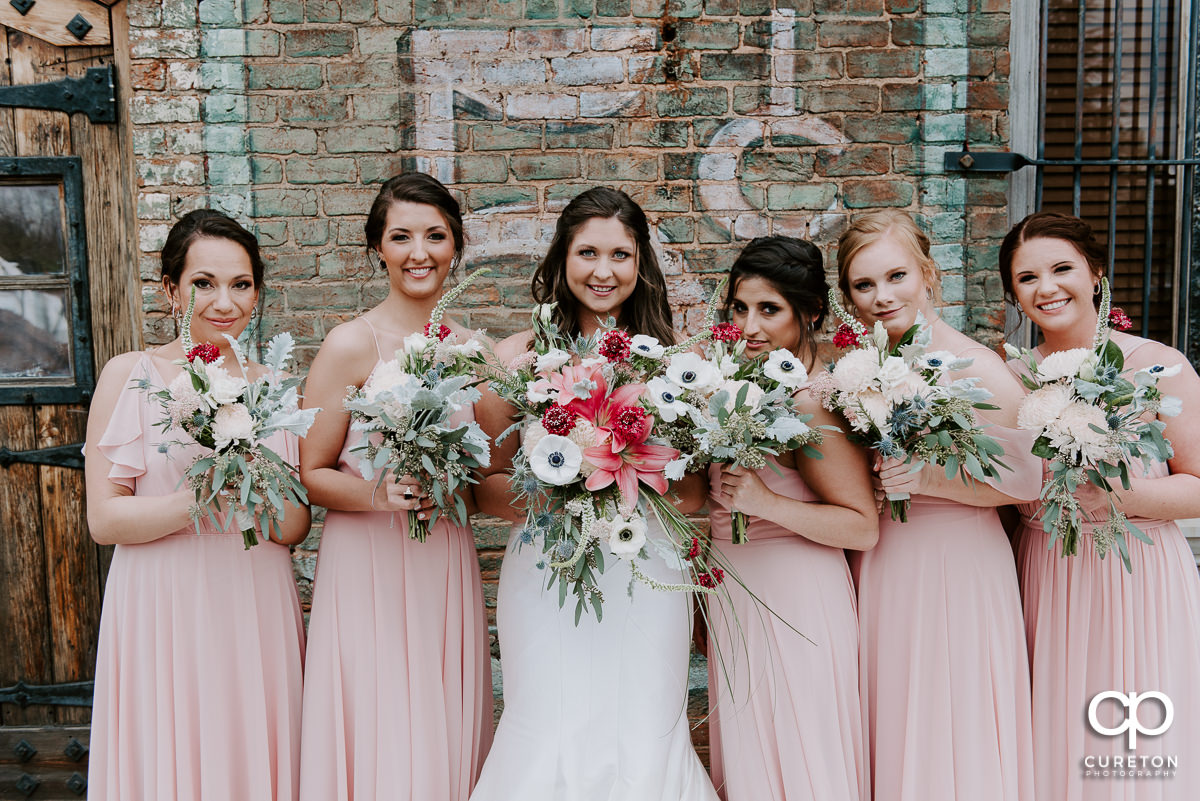 Bride and her bridesmaids on the deck of The Old Cigar Warehouse in Greenville.