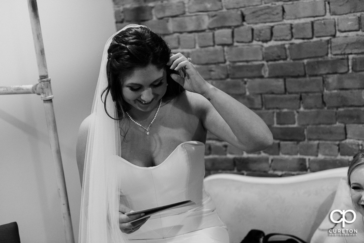 Bride reading a letter from her groom.