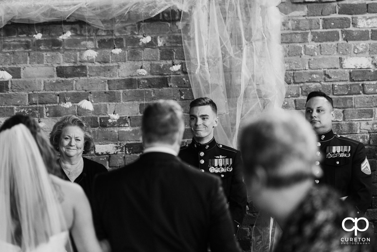 Groom sees his bride for the first time walking down the aisle.