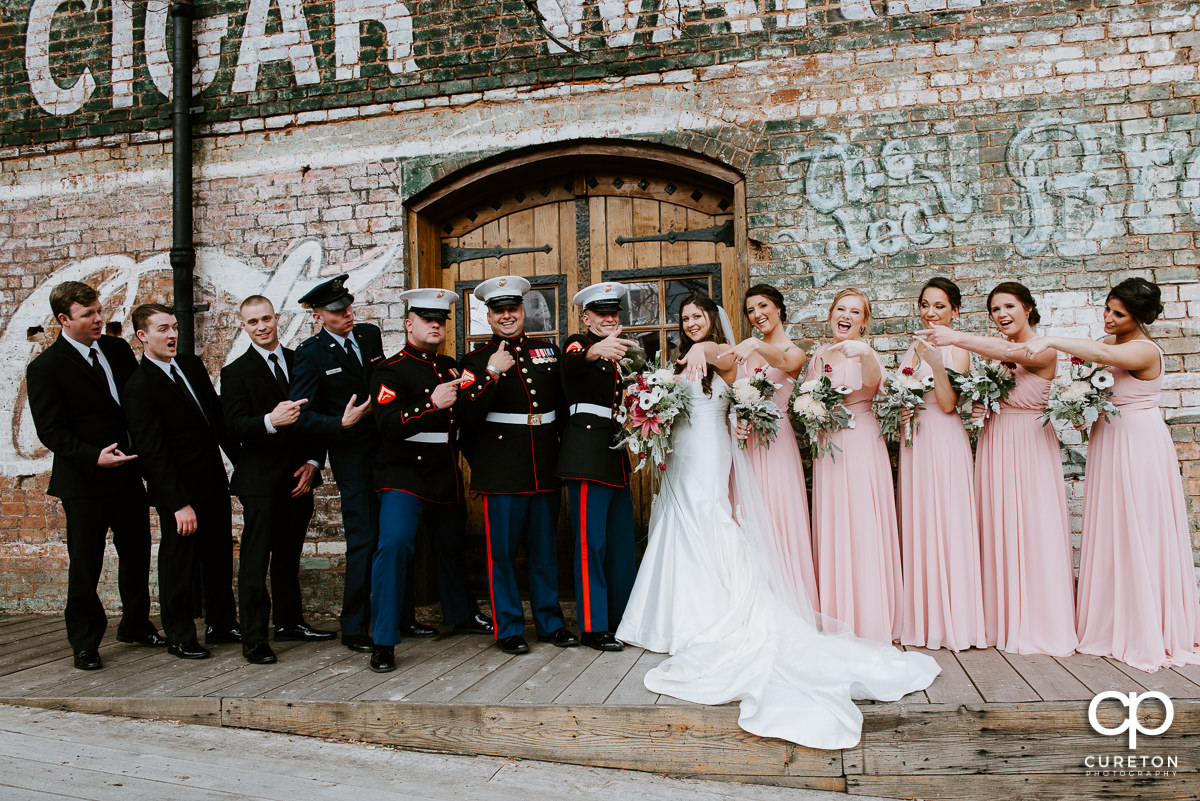 Wedding party laughing on the back deck of Old Cigar Warehouse.