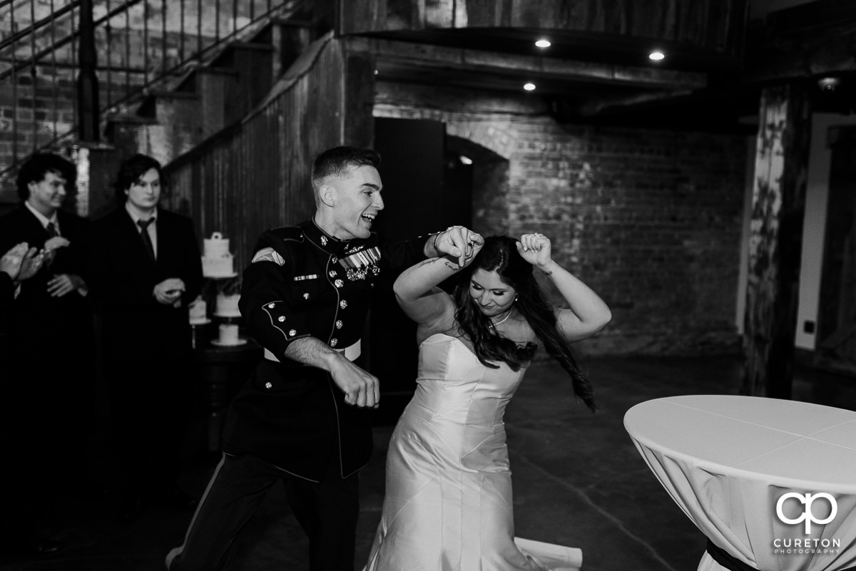 Bride and groom entering the reception dancing.
