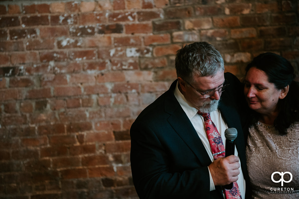 Bride's father getting emotional during a welcome speech at the reception.