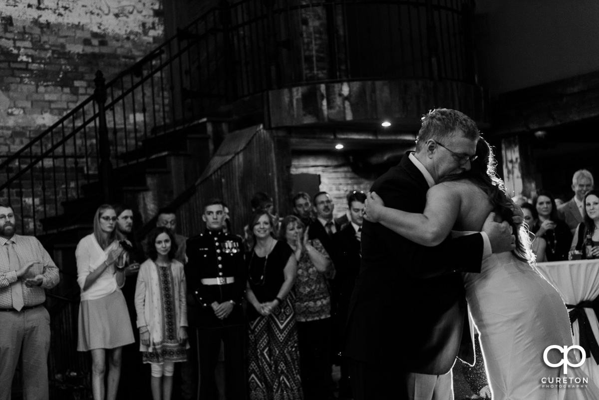 Bride hugging her father.