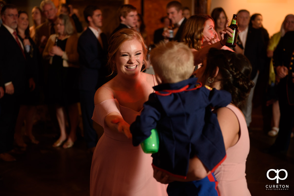 Wedding guests smiling and dancing at The Old Cigar Warehouse.