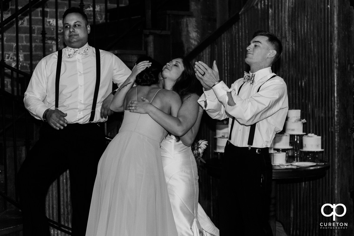 Bride hugging her bridesmaid after a speech.