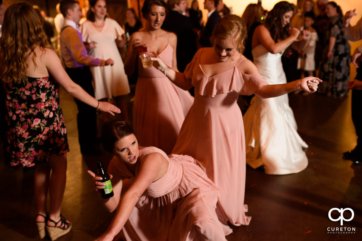 Wedding guests smiling and dancing at The Old Cigar Warehouse.