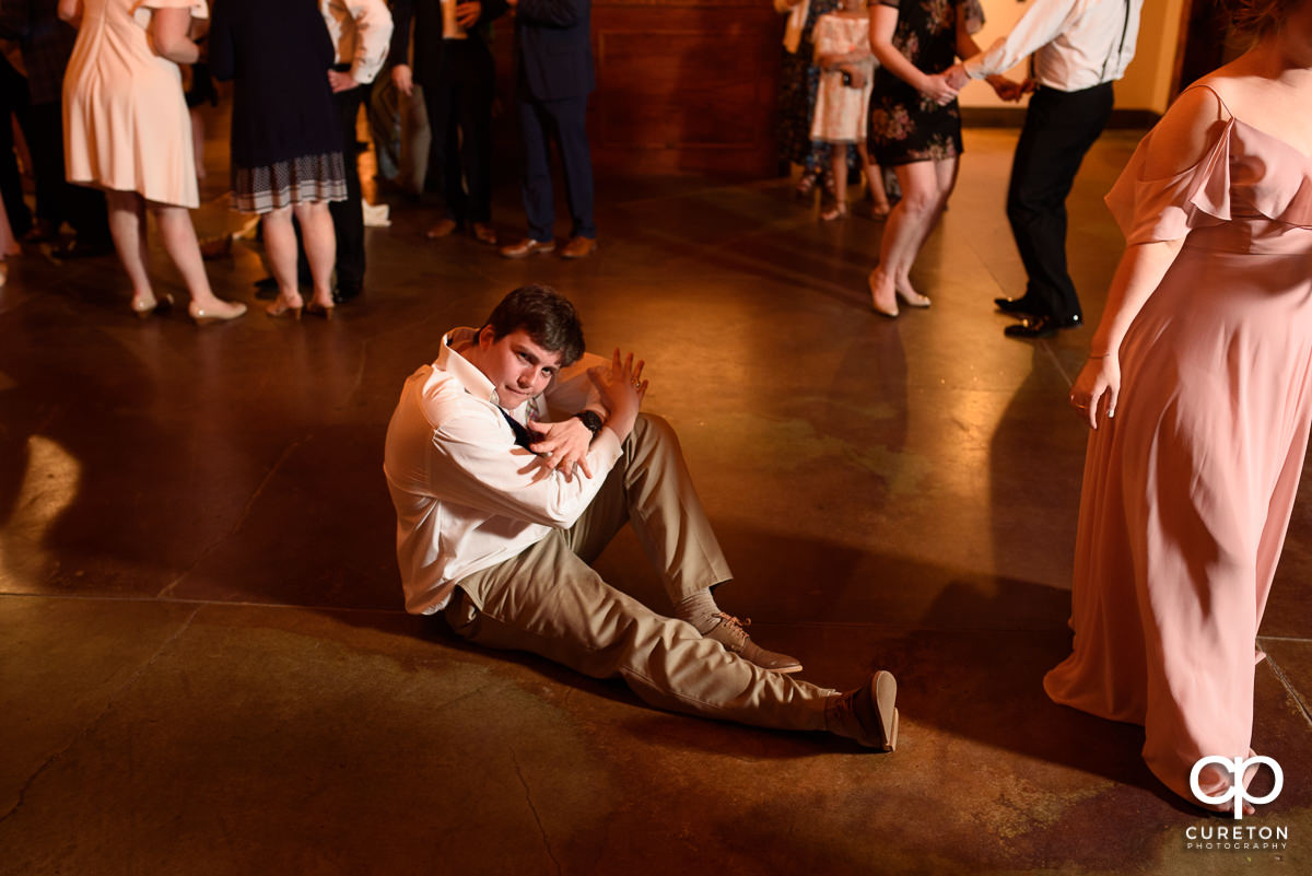 Wedding guests smiling and dancing at The Old Cigar Warehouse.