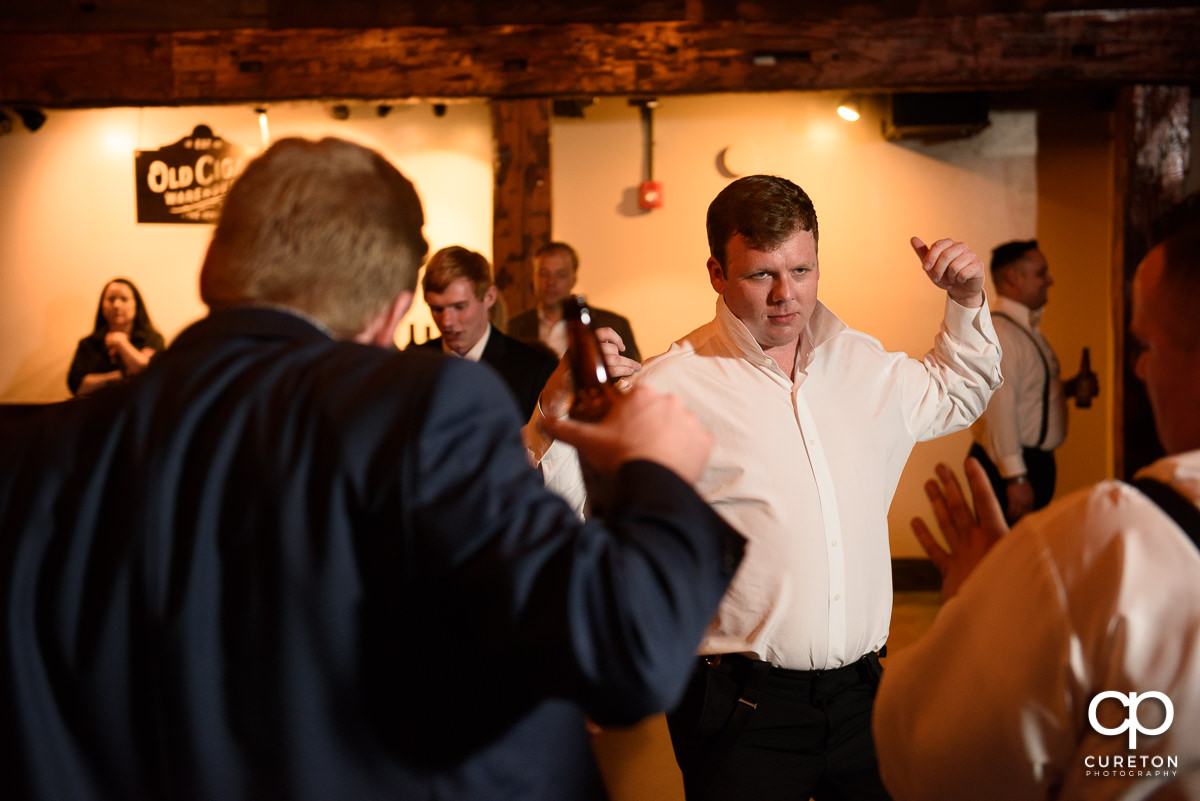 Wedding guests smiling and dancing at The Old Cigar Warehouse.