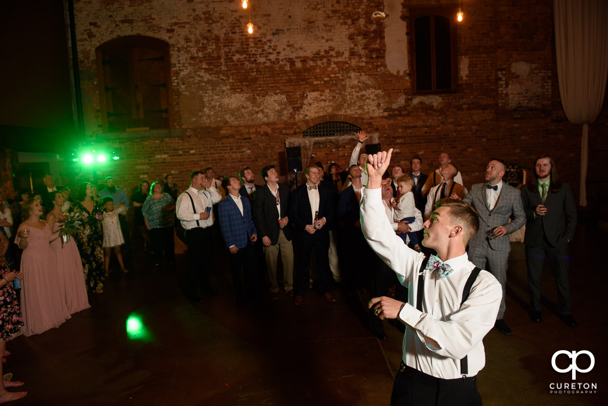 Groom tossing the garter.