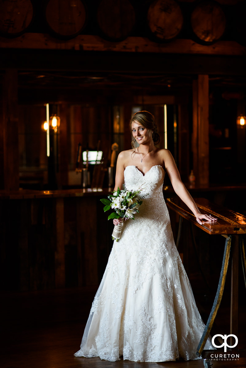 Bride in the whiskey bar during her bridal session at Revel Event Center in Greenville,SC.
