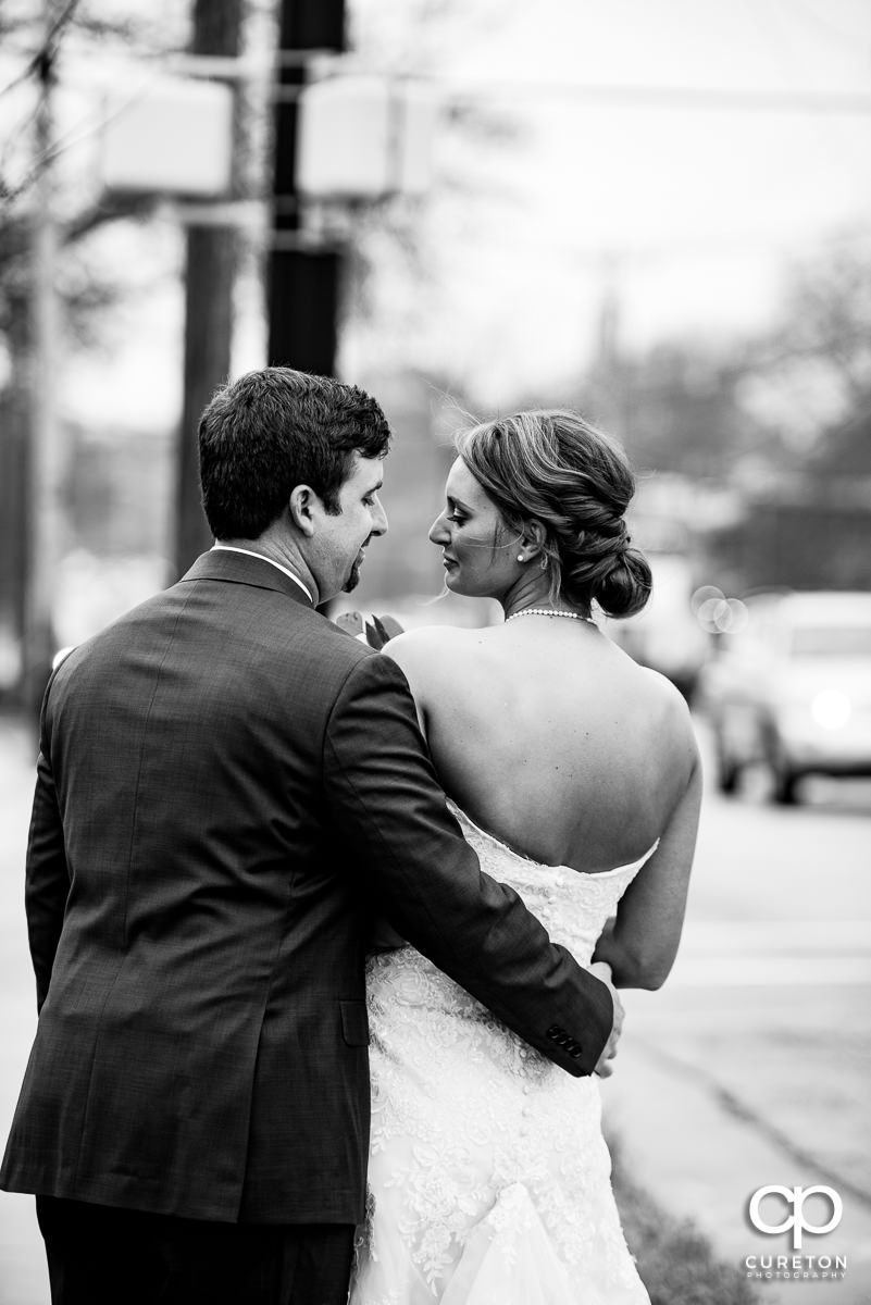 Bride and groom walking down Stone Avenue in Greenville,SC.