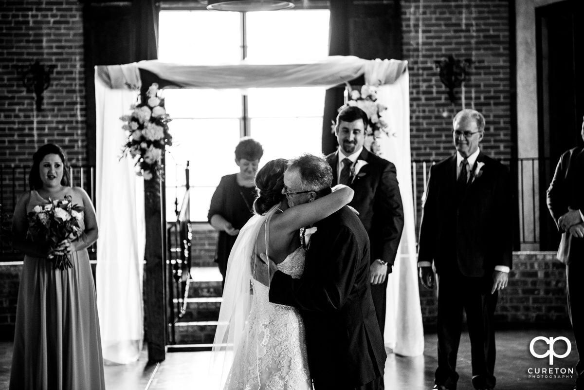 Bride hugging her father.