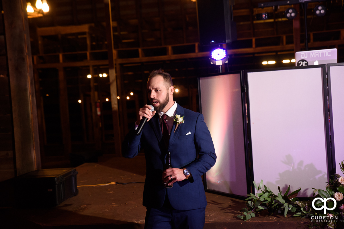 Groom singing at the reception.