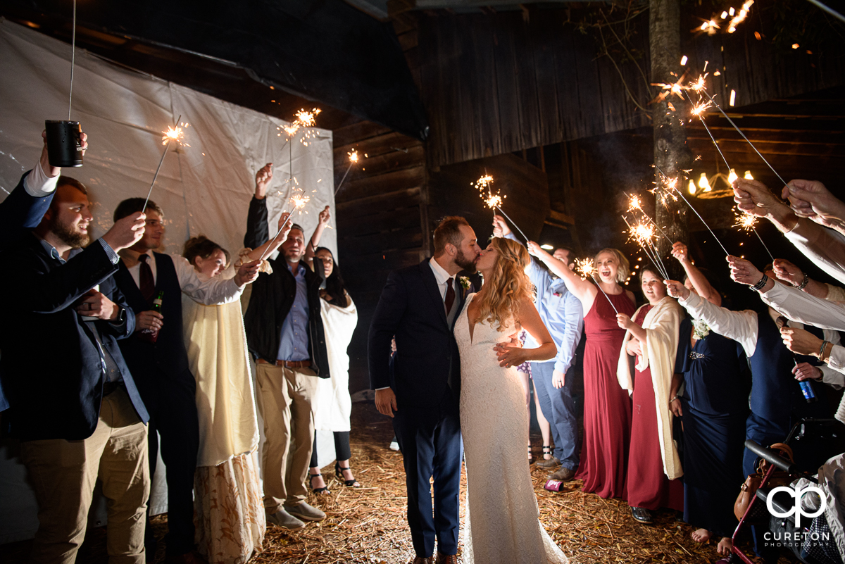 Bride and groom making a grand sparkler exit .