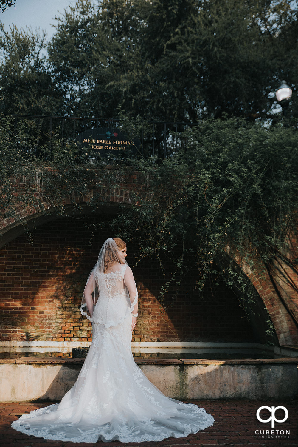 Bride under the bridge in the rose garden.