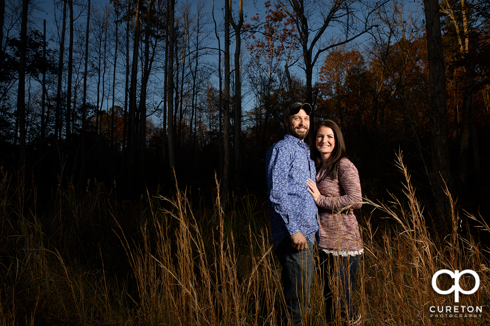 Engaged couple in a field.