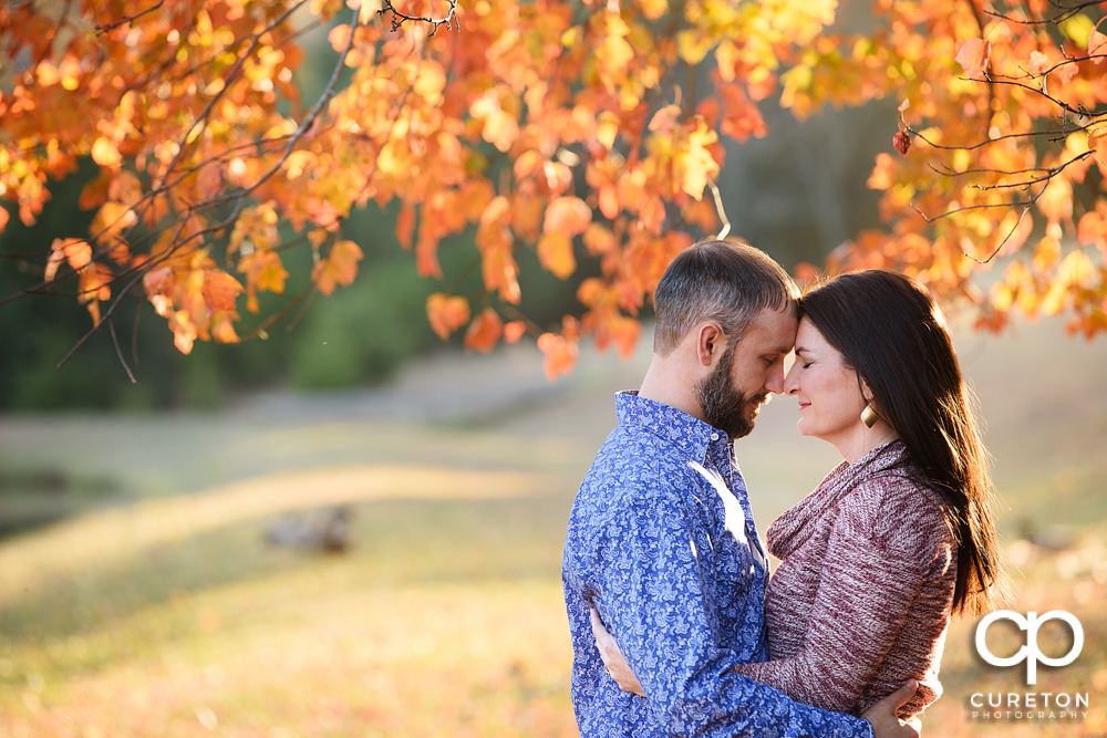 Engaged couple hugging.