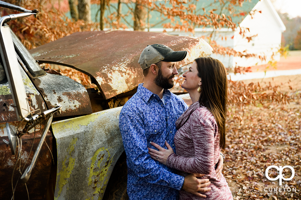 Engaged couple staring into each others eyes.