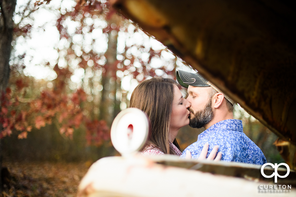 Future bride and groom kissing.