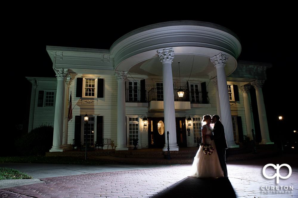 Bride and groom in front of the mansion during their Ryan Nicholas Inn wedding.