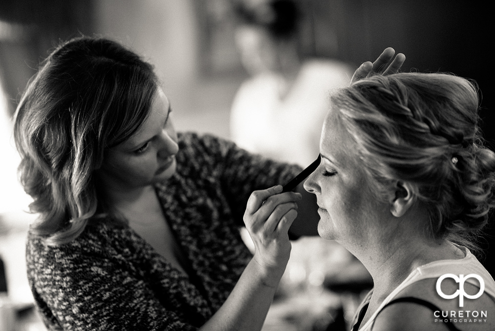 Bride getting her makeup applied.