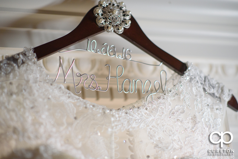 Bride's dress on a hanger.