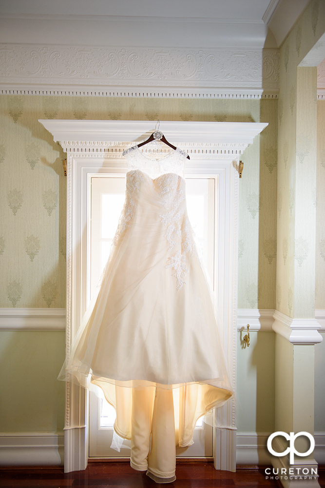 Bride's dress hanging.