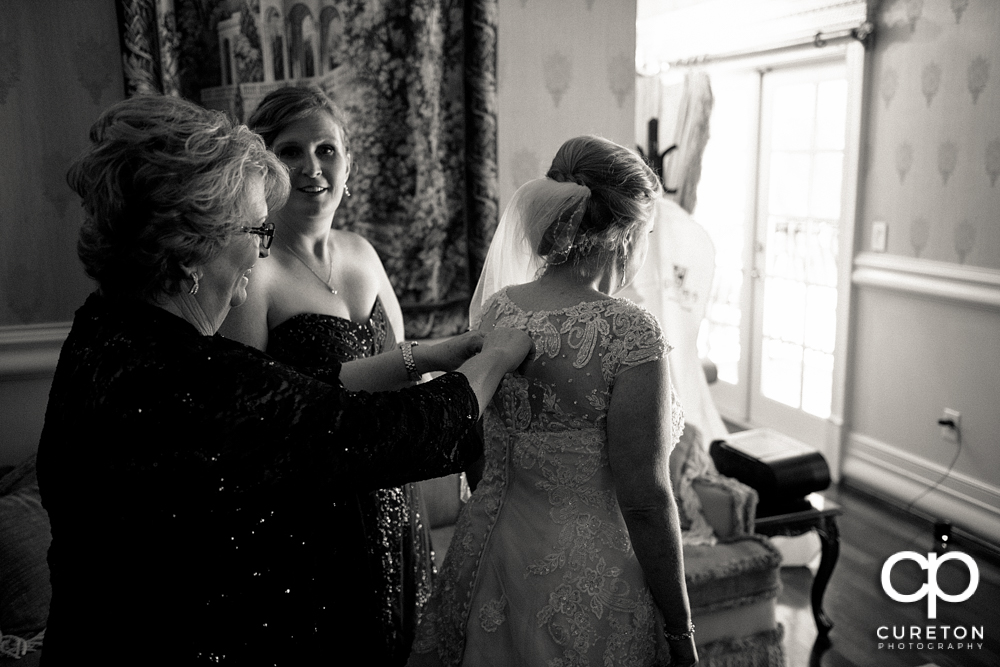 The bride putting her dress on.