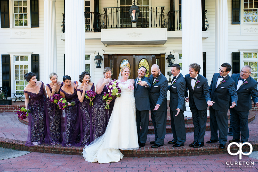 The wedding party looking at the ring.