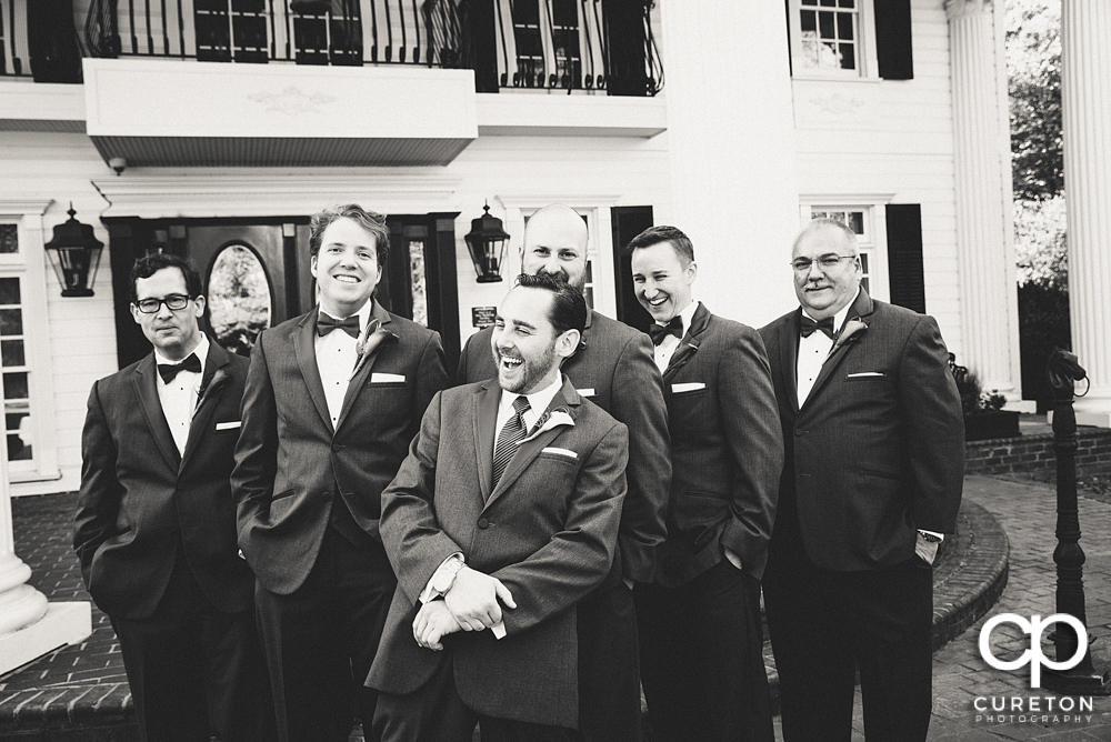 The groomsmen laughing.