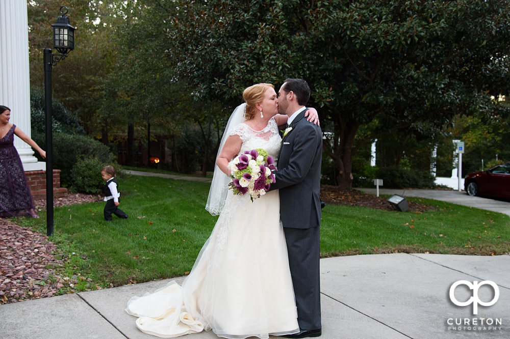 Bride and groom kissing after the ceremony.