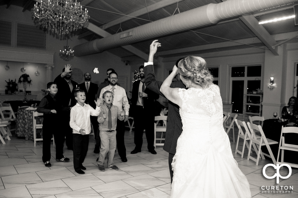 Groom tossing the garter.