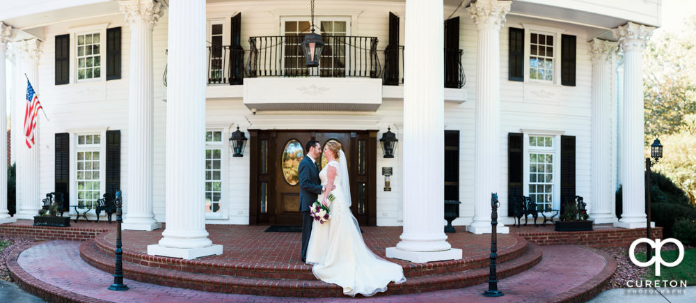 Bride and Groom pano in front of the Ryan Nicholas Inn.