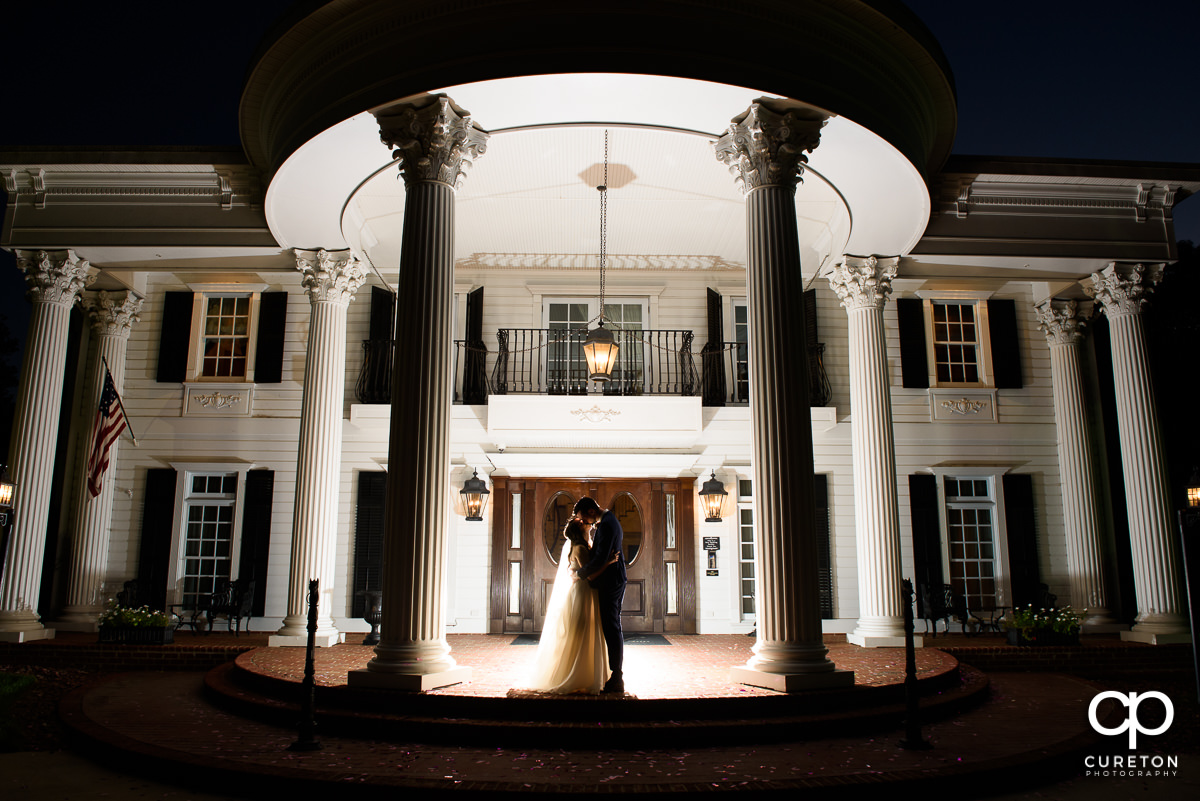 Epic shot of newlyweds in front of the house after their Ryan Nicholas Inn wedding.
