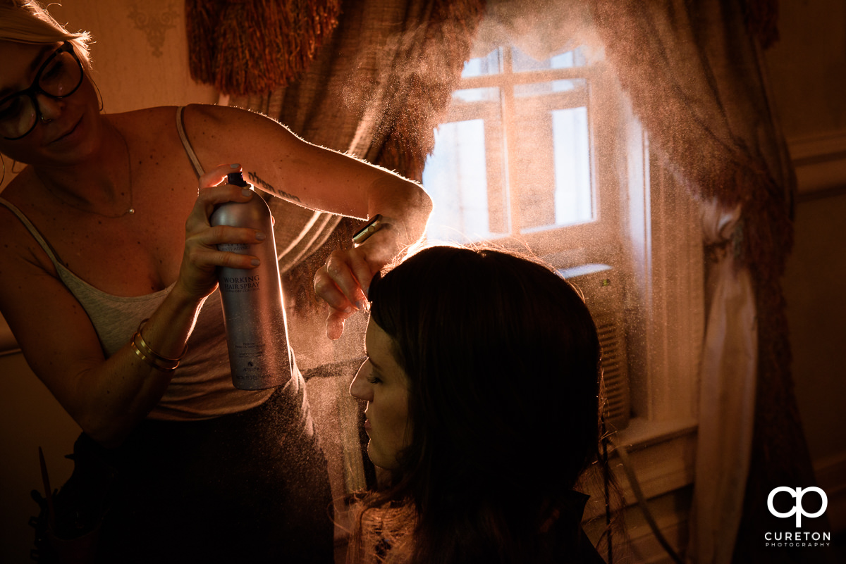 Epic shot of bride getting hair spray put on.