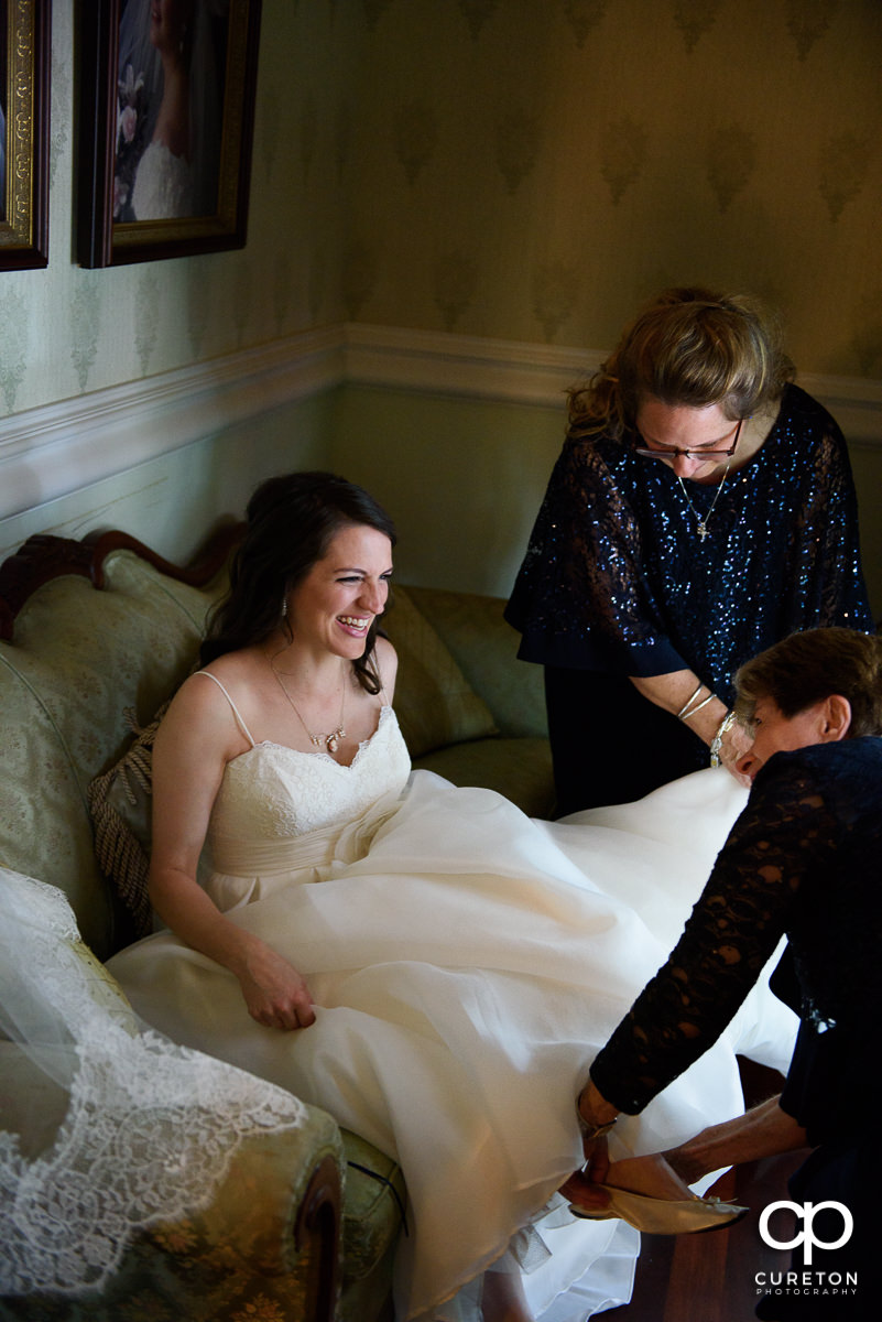 Bride laughing while getting ready in the bridal suite.