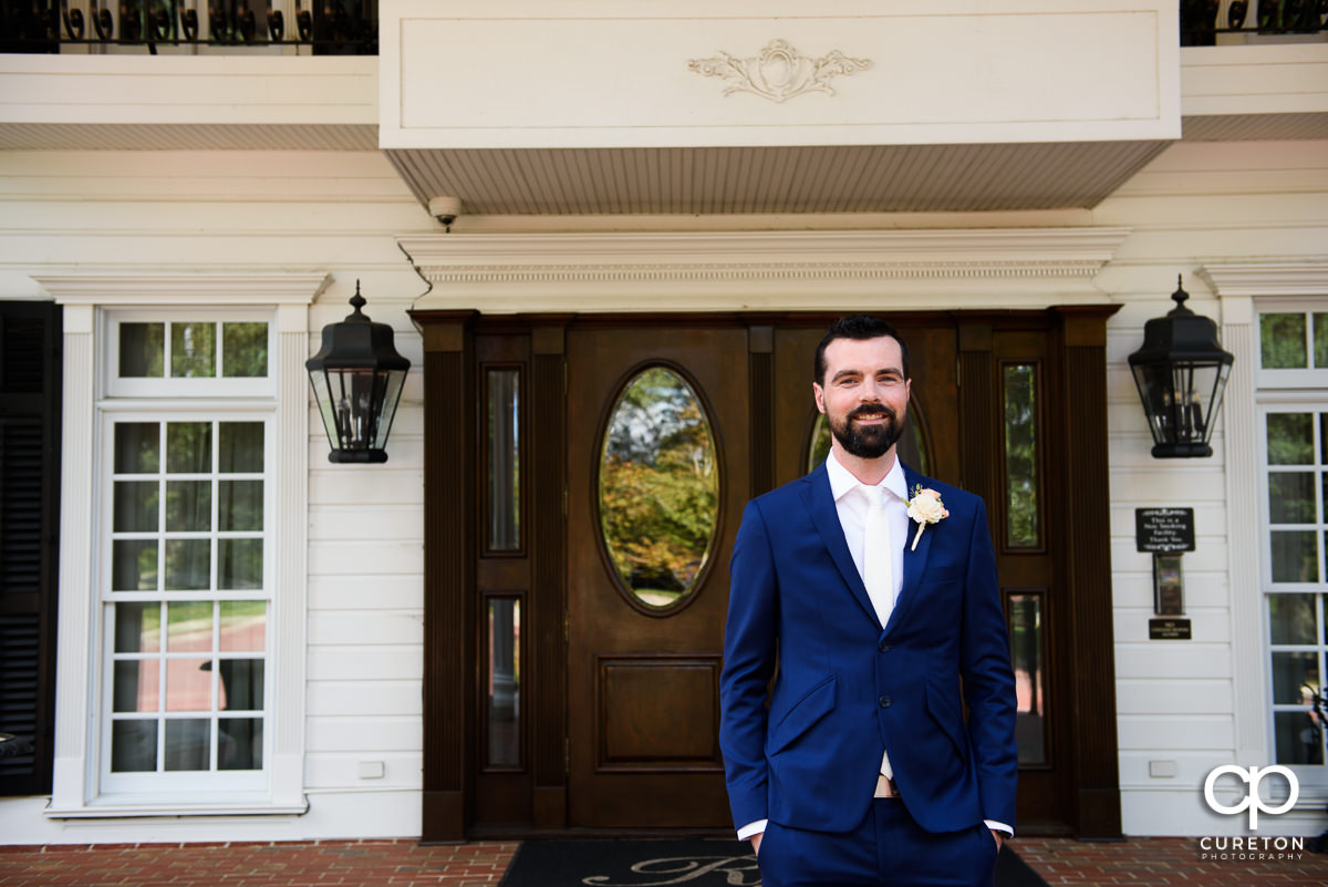 Groom on the porch of the Ryan Nicholas Inn awaiting the first look with his bride.