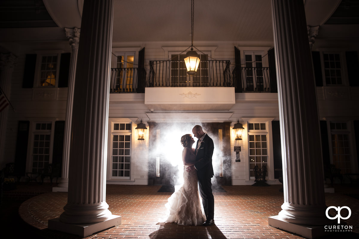Bride and groom on the porch of the Ryan Nicholas Inn.