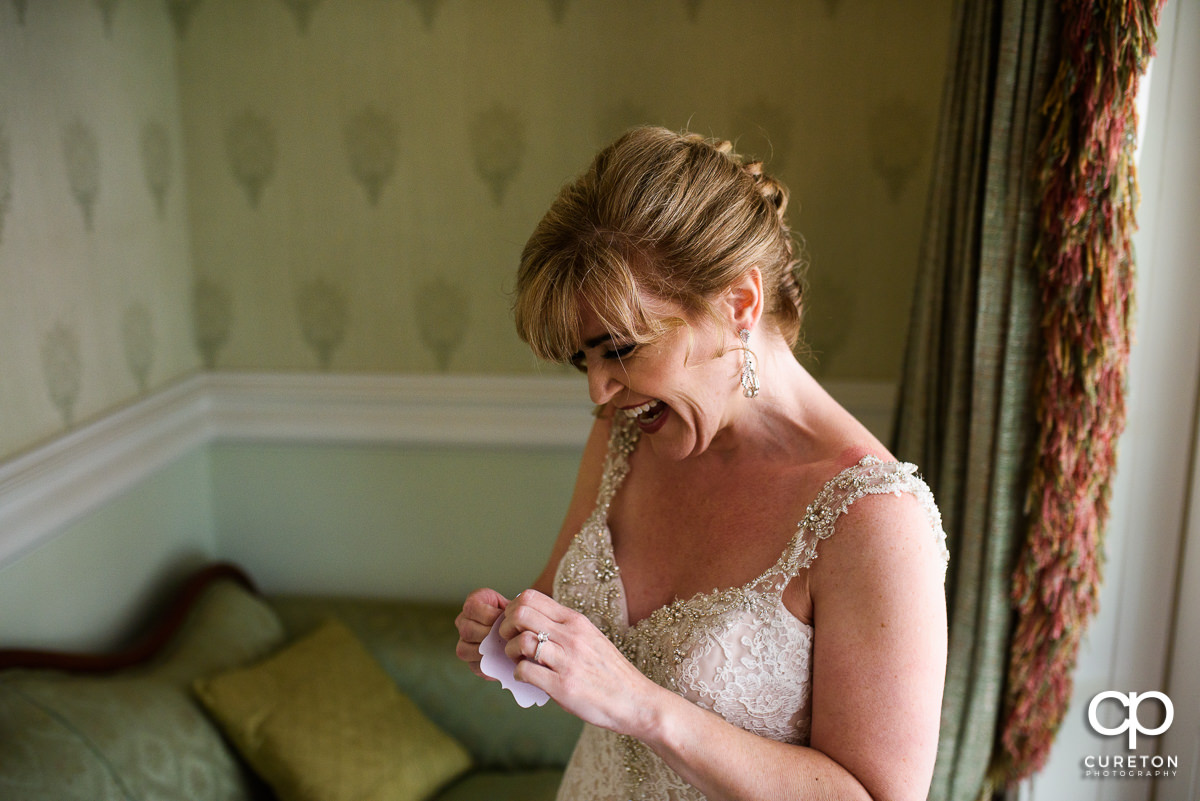 Bride laughing while getting ready.
