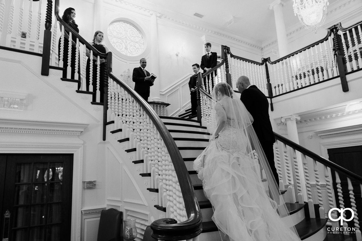 Bride and groom walking up the steps during the Ryan Nicholas Inn wedding ceremony.