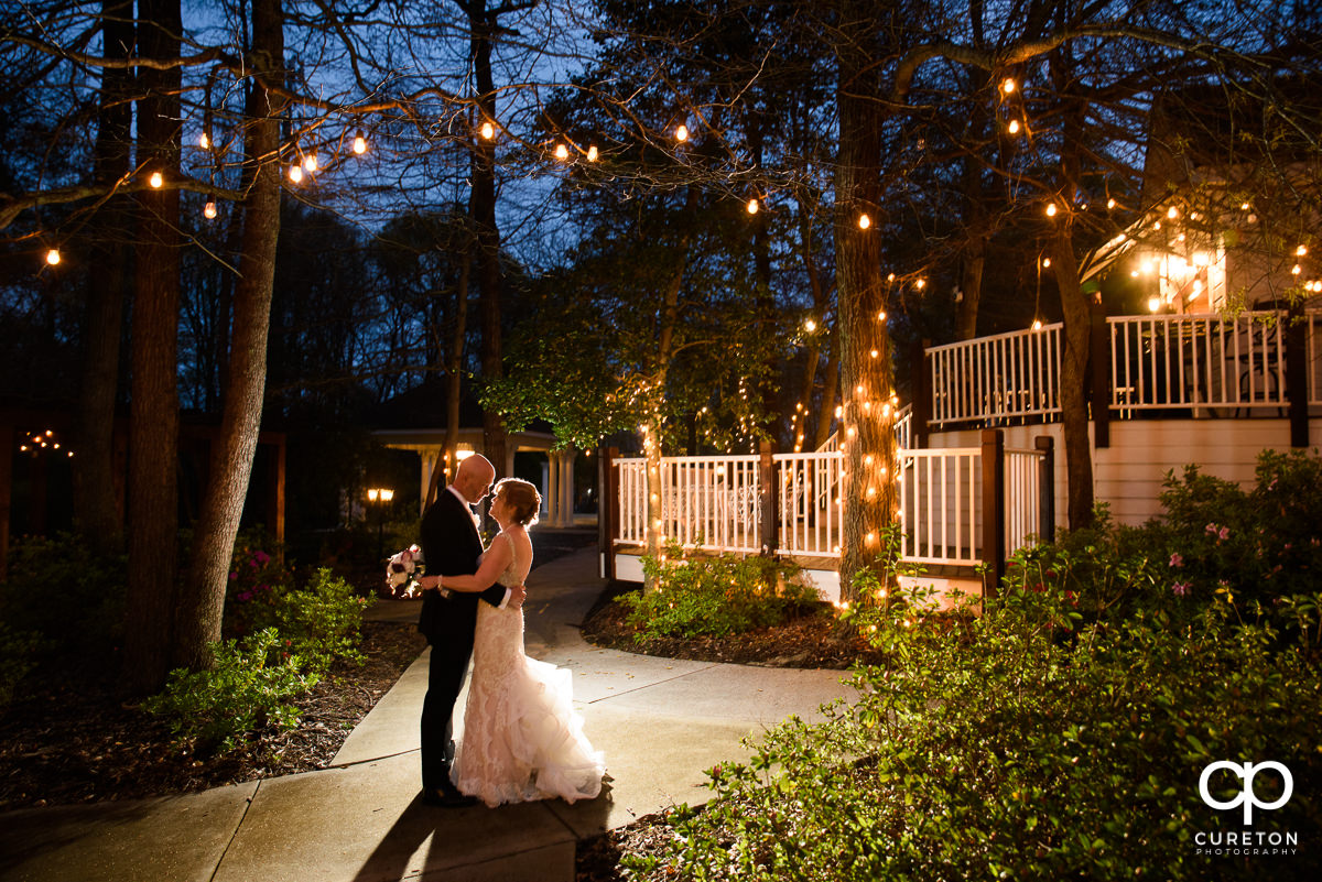 Bride and groom at twilight in the garden of The Ryan Nicholas Inn.