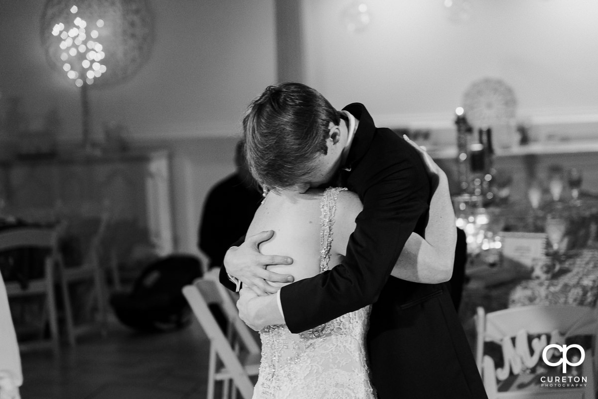 Groom's son hugging the bride.