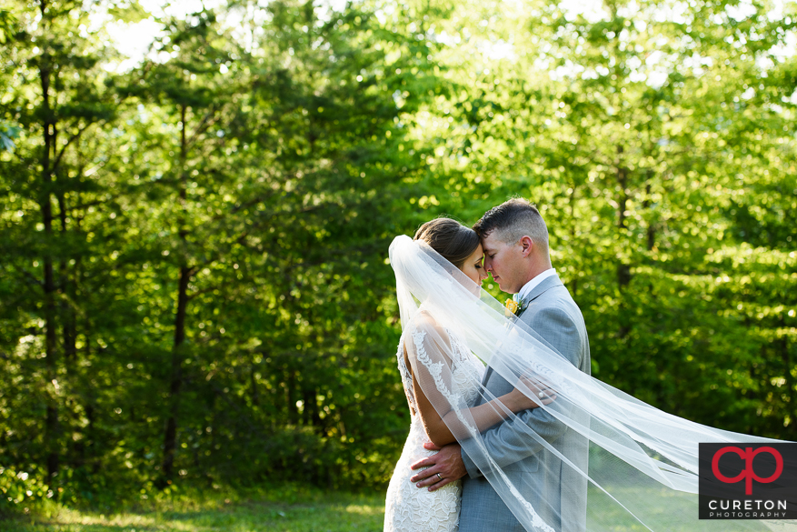 Bride and groom forehead to forehead after their wedding.