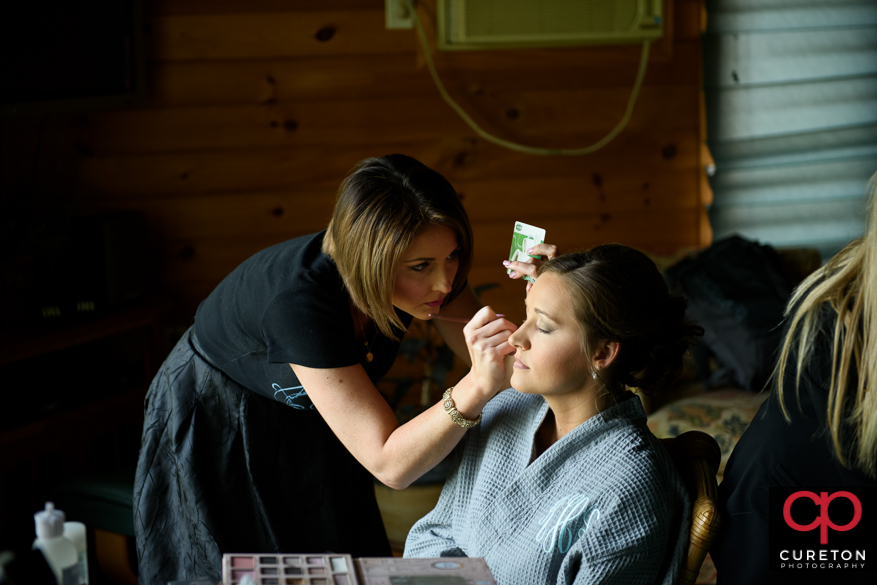 Bride having airbrushed makeup applied.