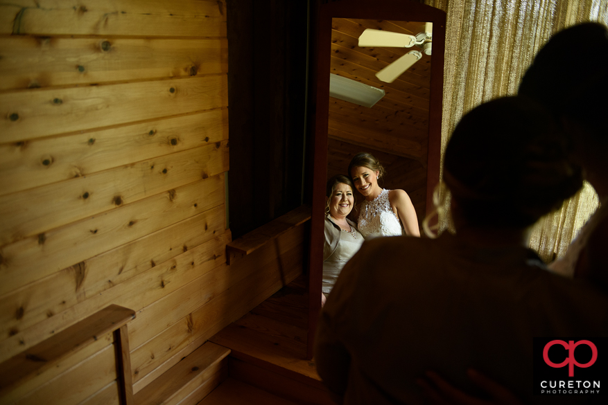 Bride and mom share a moment in the getting ready room at Song Hill Reserve.